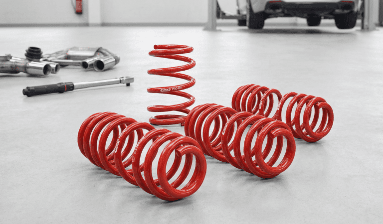 A bunch of red springs sitting on top of a floor