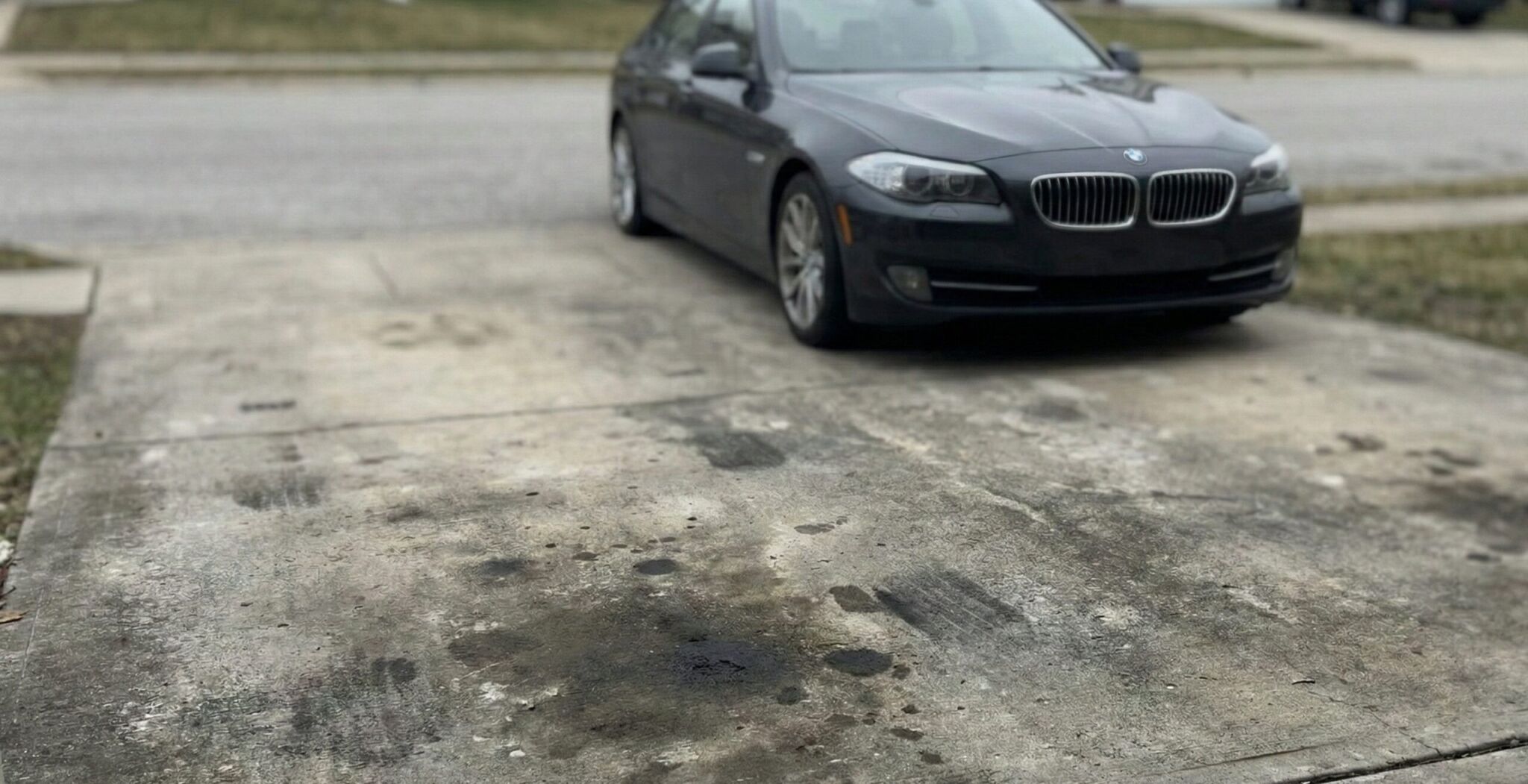 A black car parked on the side of a road